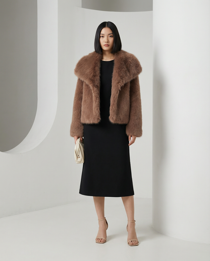 Cocoa brown Neriah faux-fur jacket with a broad shawl collar, front view over a black midi dress