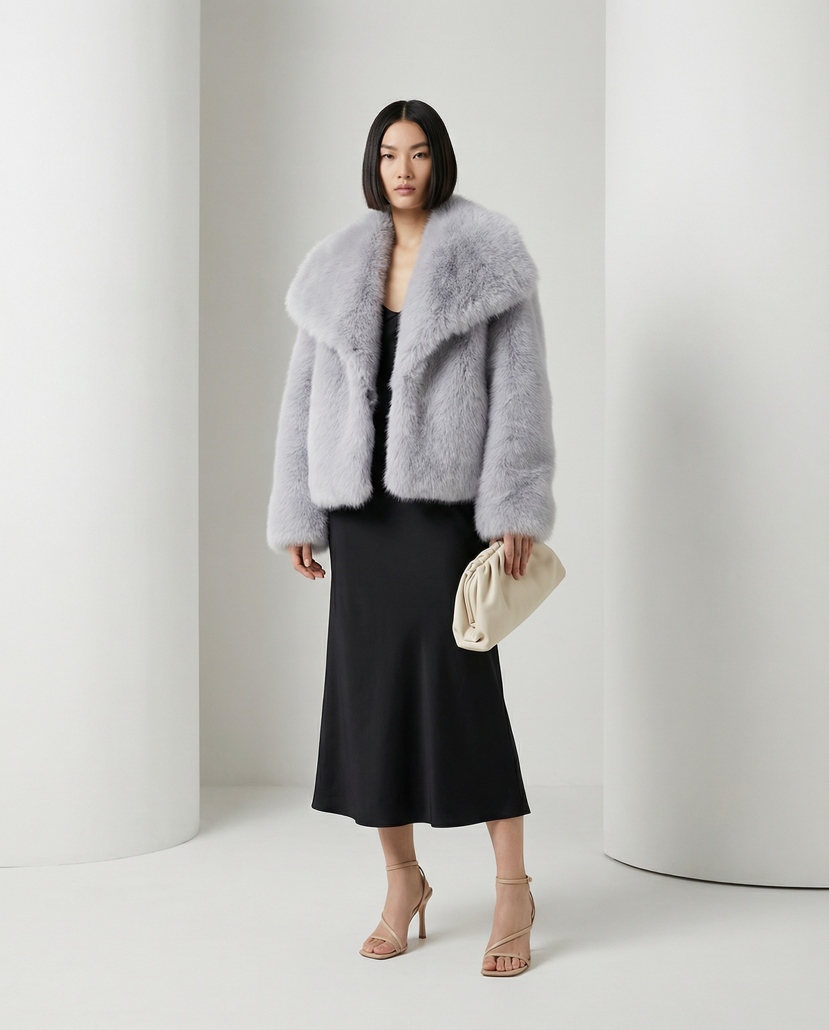 Pale silver-grey Neriah plush faux-fur jacket worn open over a black bias-cut midi dress