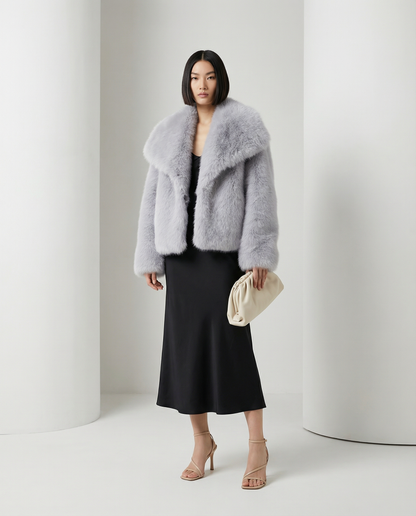 Pale silver-grey Neriah plush faux-fur jacket worn open over a black bias-cut midi dress
