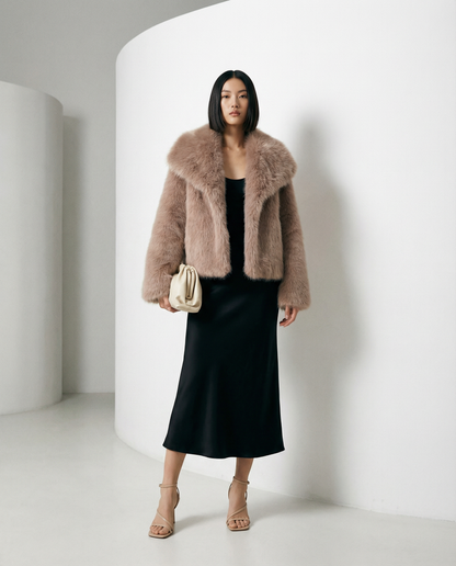 Rose gold Neriah plush faux-fur jacket in dusty pink, worn open over a black slip midi dress