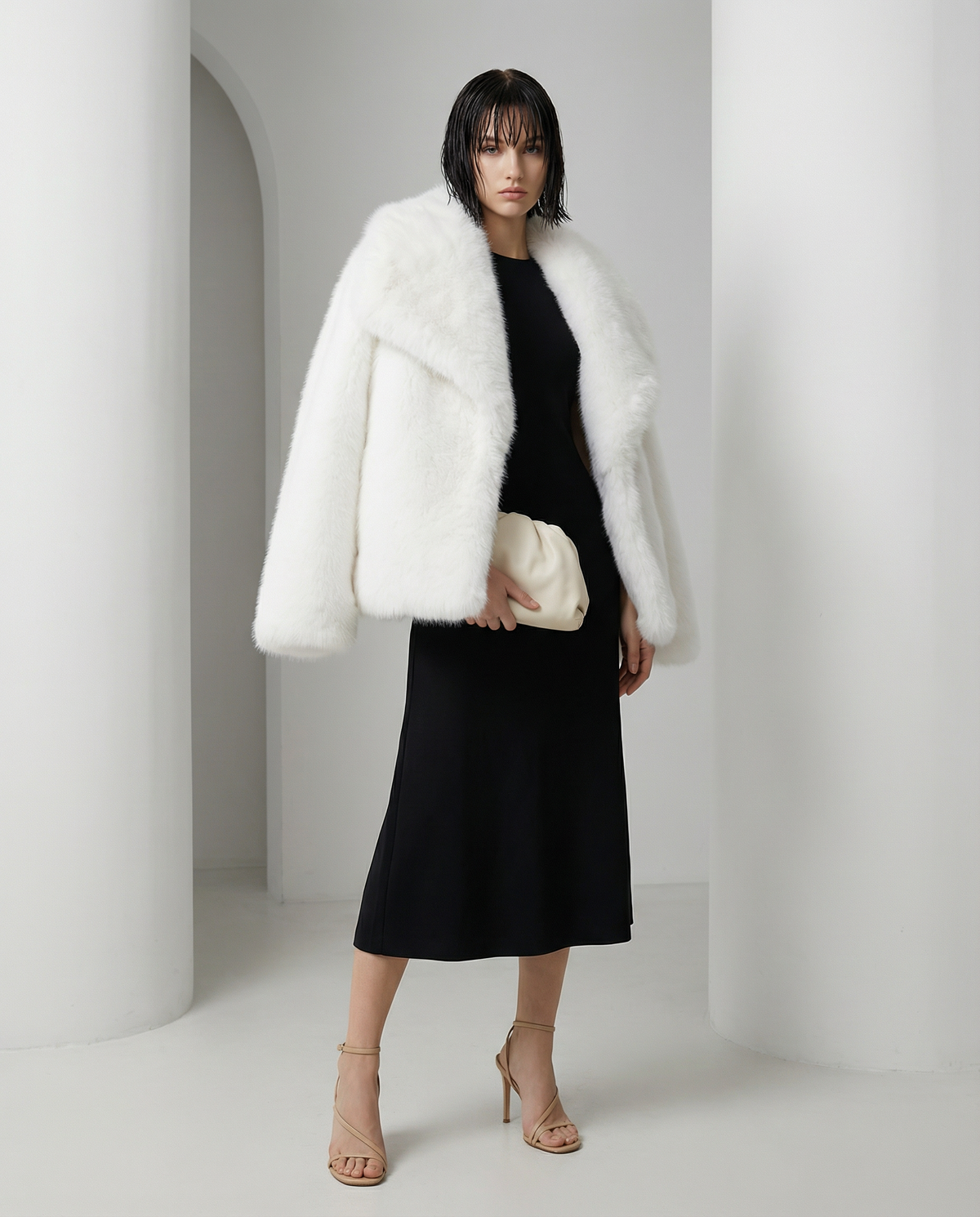 White Neriah plush faux-fur jacket with a deep shawl collar, worn over a black knit midi dress