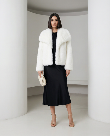 Neriah faux-fur jacket in white, straight-on front view over a black bias-cut midi dress