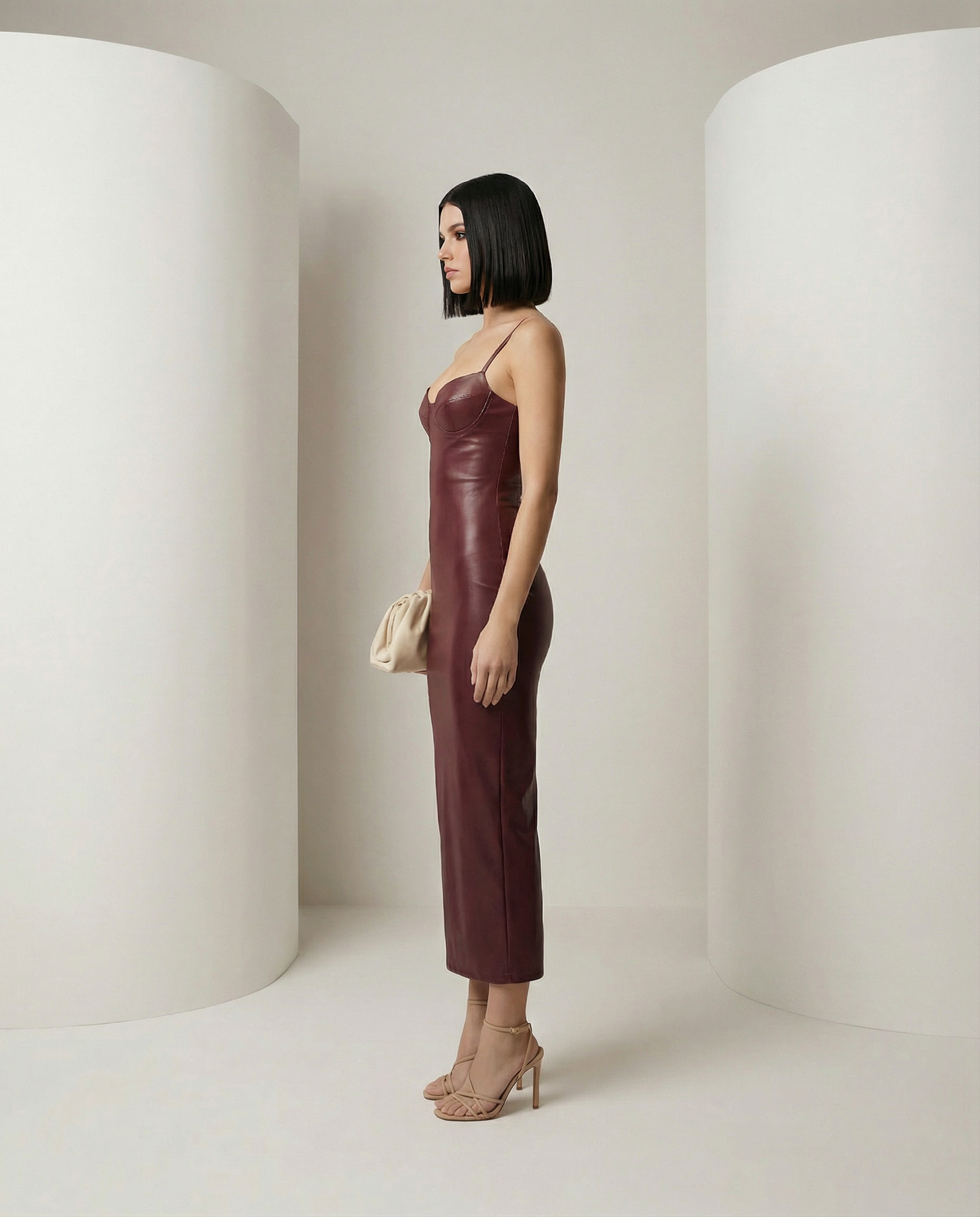 Noira bodycon dress in oxblood shown from the side, body-skimming fit with hem at mid-calf