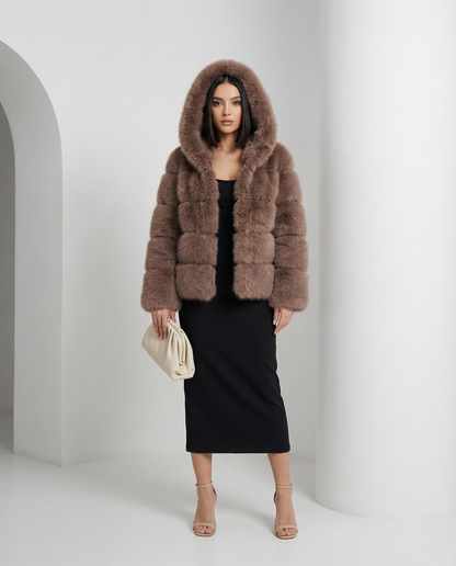 Taupe brown faux-fur bubble jacket with the hood up over a black pencil midi dress, full length