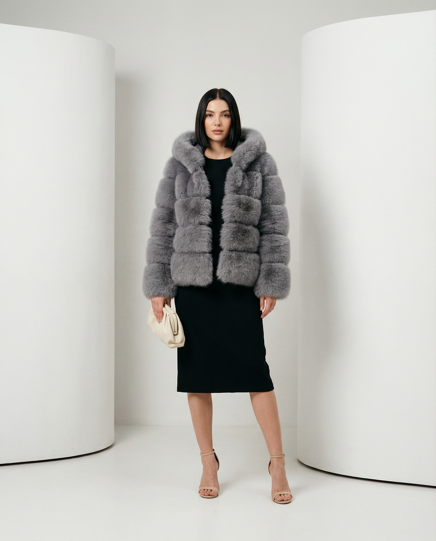 Nova faux-fur bubble jacket in grey worn open over a black pencil midi dress, full length front view