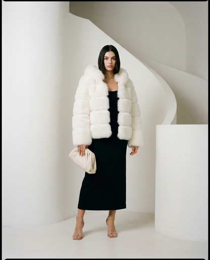 Nova faux-fur bubble jacket in cream white over a long black column dress, full length by a staircase