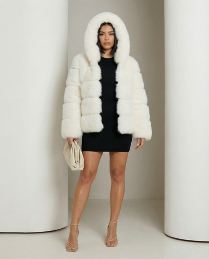 Cream faux-fur bubble jacket with the hood up over a black mini dress, full length front view