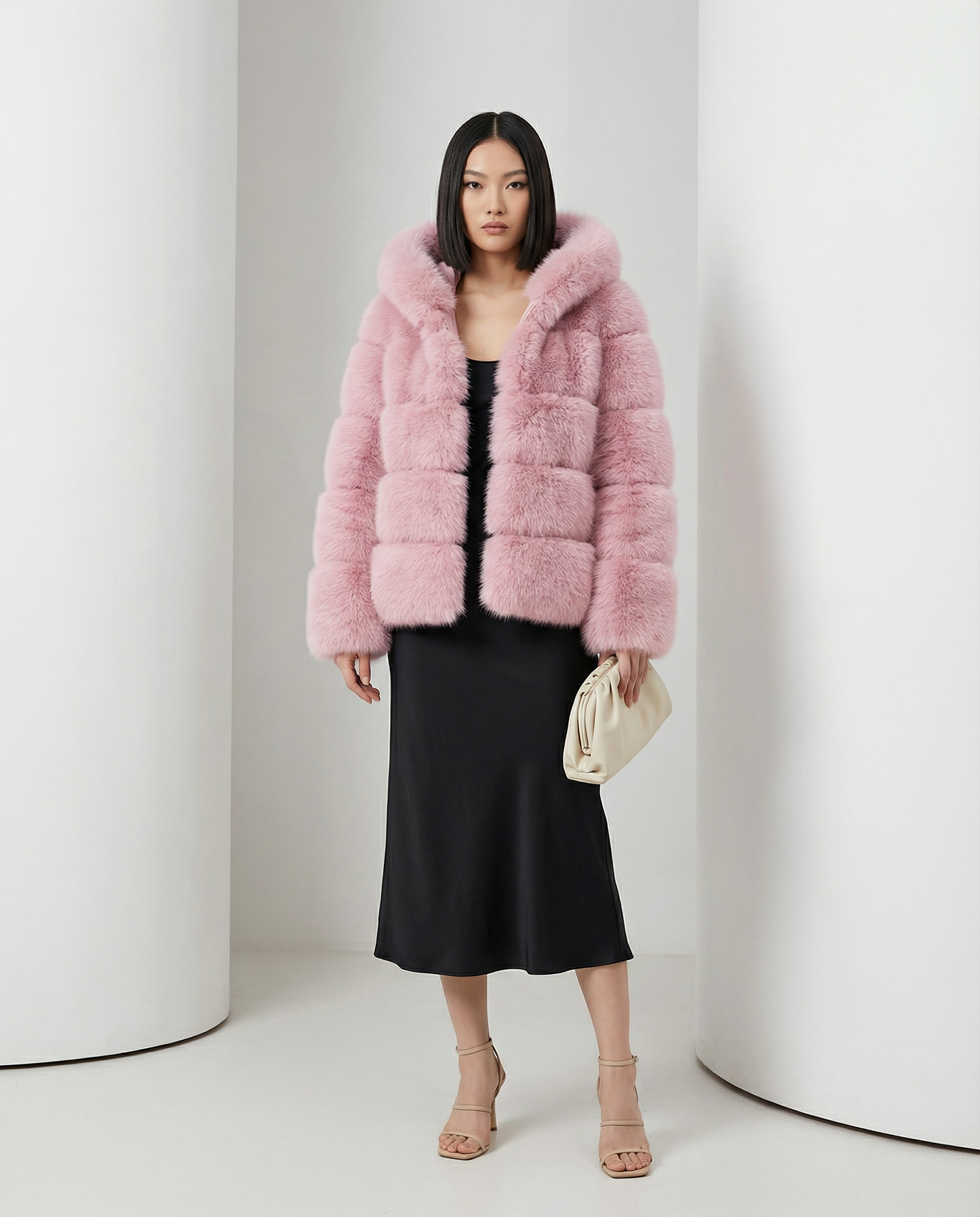 Pink Nova faux-fur bubble jacket worn open over a black slip midi dress, full length standing