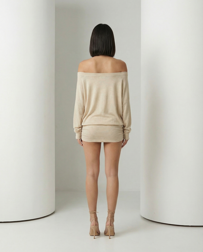 Back view of the beige off-shoulder mini dress with elasticated neckline and ruched skirt