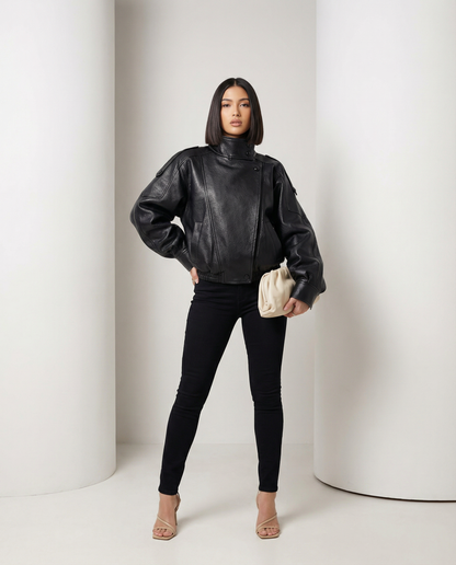 Black leather-look Onyx Jacket worn over skinny jeans, front view standing with hand on hip