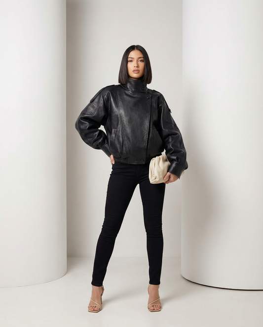 Black leather-look Onyx Jacket worn over skinny jeans, front view standing with hand on hip