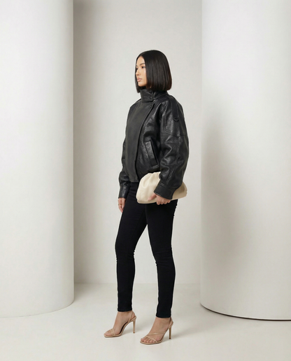 Onyx Jacket in black with the funnel collar fastened high, side profile, full length