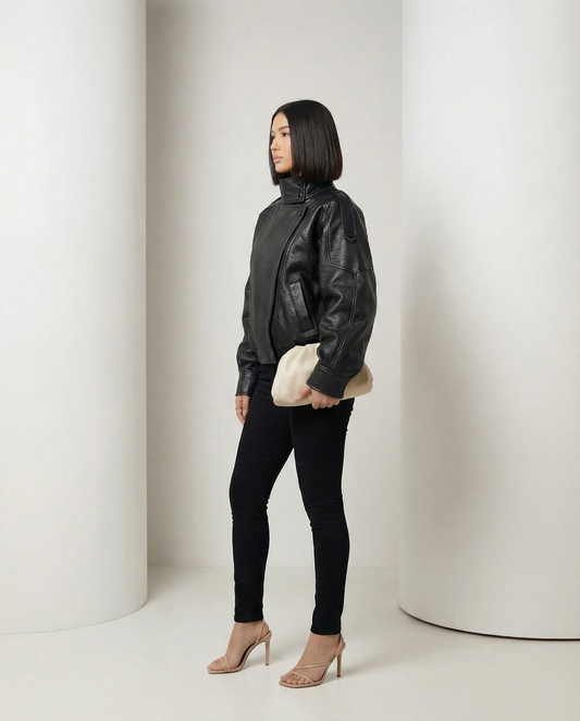 Onyx Jacket in black with the funnel collar fastened high, side profile, full length
