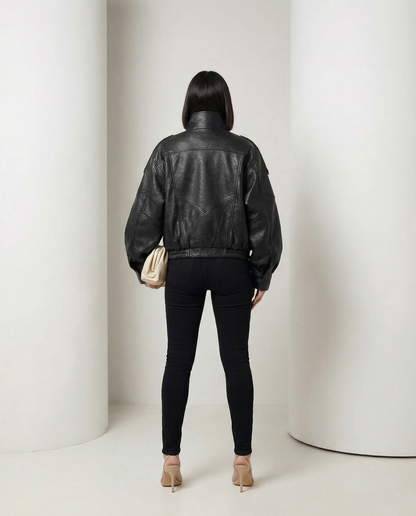 Black oversized leather-look bomber from behind, yoke seaming and banded hem, full length