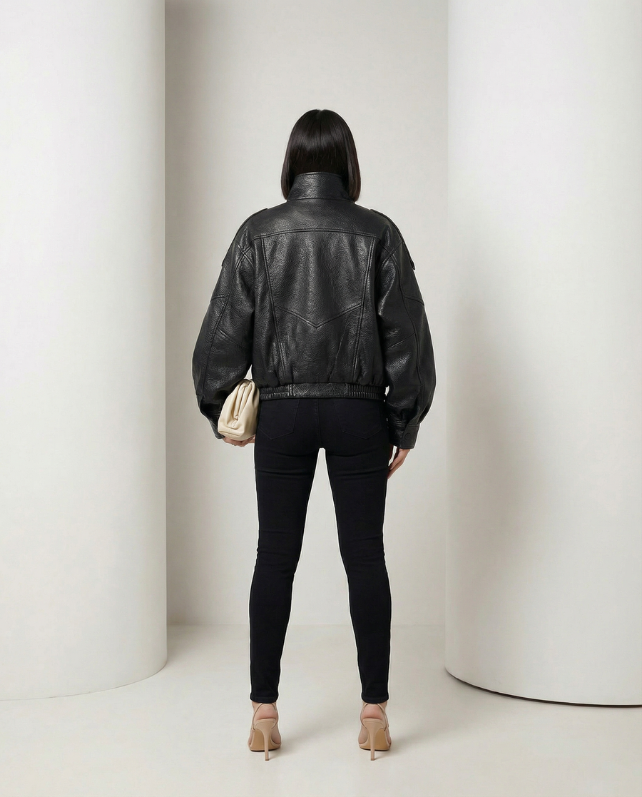 Black leather-look Onyx Jacket worn over skinny jeans, front view standing with hand on hip