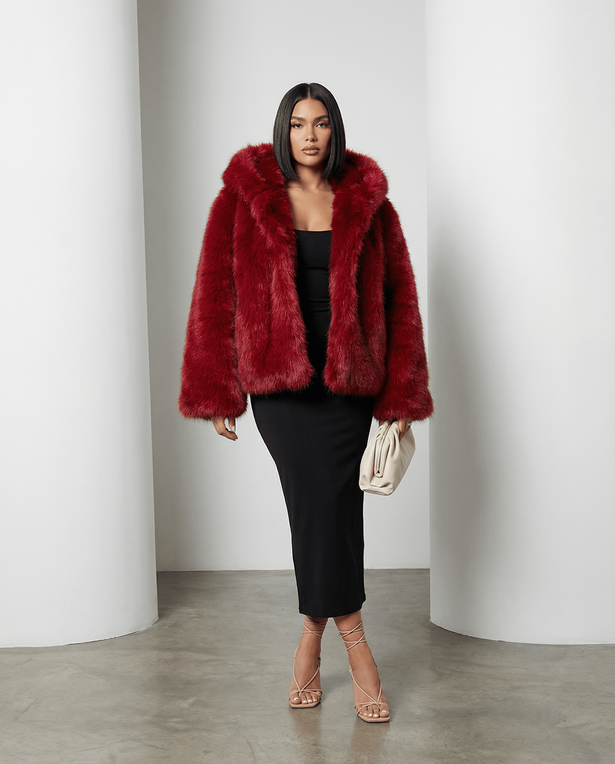 Scarlet red Ravena hooded faux-fur jacket worn open over a black midi dress, full length