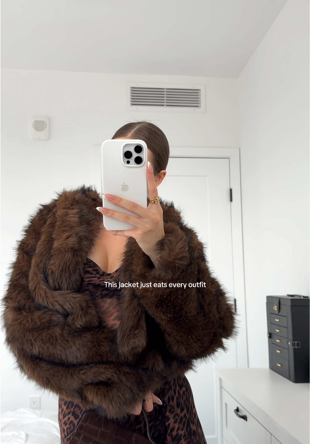 Cropped brown faux fur jacket in a mirror selfie, captioned 