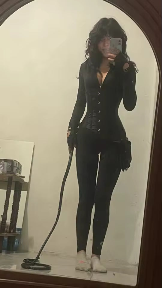Full-length black corset-detail jumpsuit with hook fastenings, arched mirror, white socks