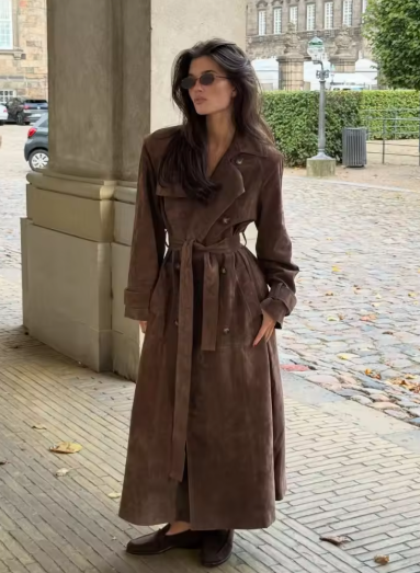 Belted double-breasted brown suede maxi trench with sunglasses and loafers on a cobbled street
