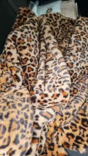 Small, blurry close-up of folded leopard-print faux fur fabric