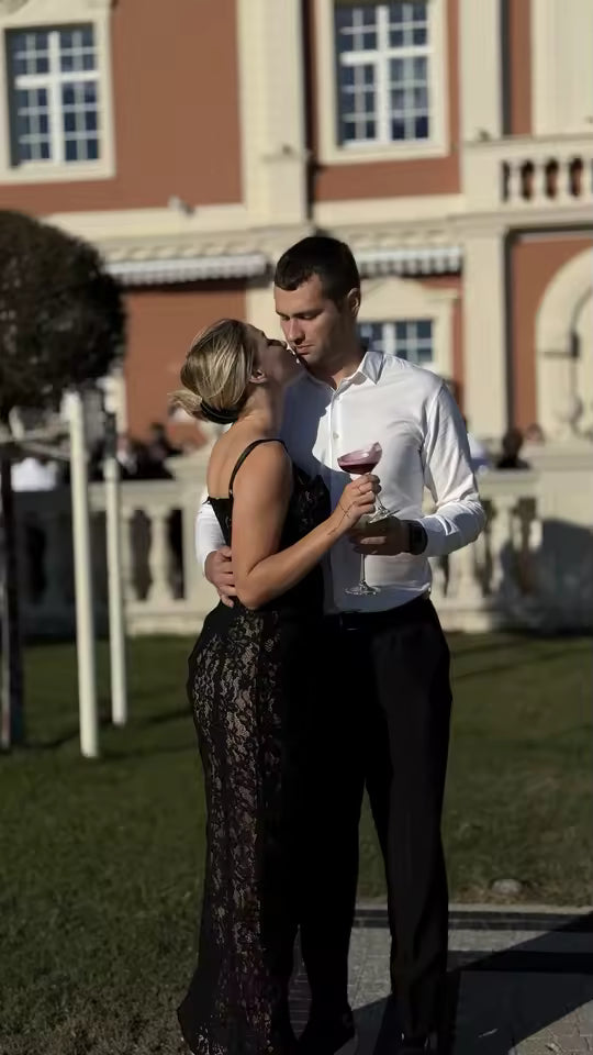 Black lace maxi dress worn at a garden party, a couple embracing outside a grand villa