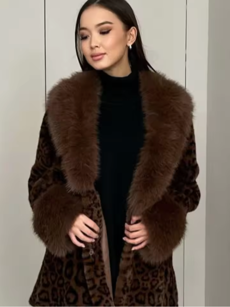 Leopard faux fur coat with a wide brown fur shawl collar over a black turtleneck