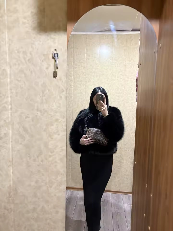 Black cropped faux-fur jacket with a long black skirt and small clutch, hallway mirror selfie