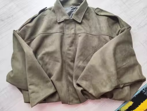 Olive suede-look jacket with a point collar, laid flat and photographed from above