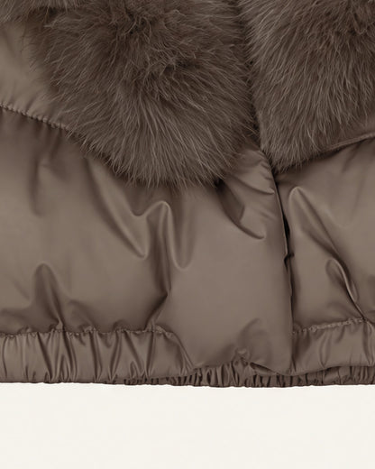 Close view of the Saga puffer hem, the gathered elastic waistband below wide horizontal quilted channels