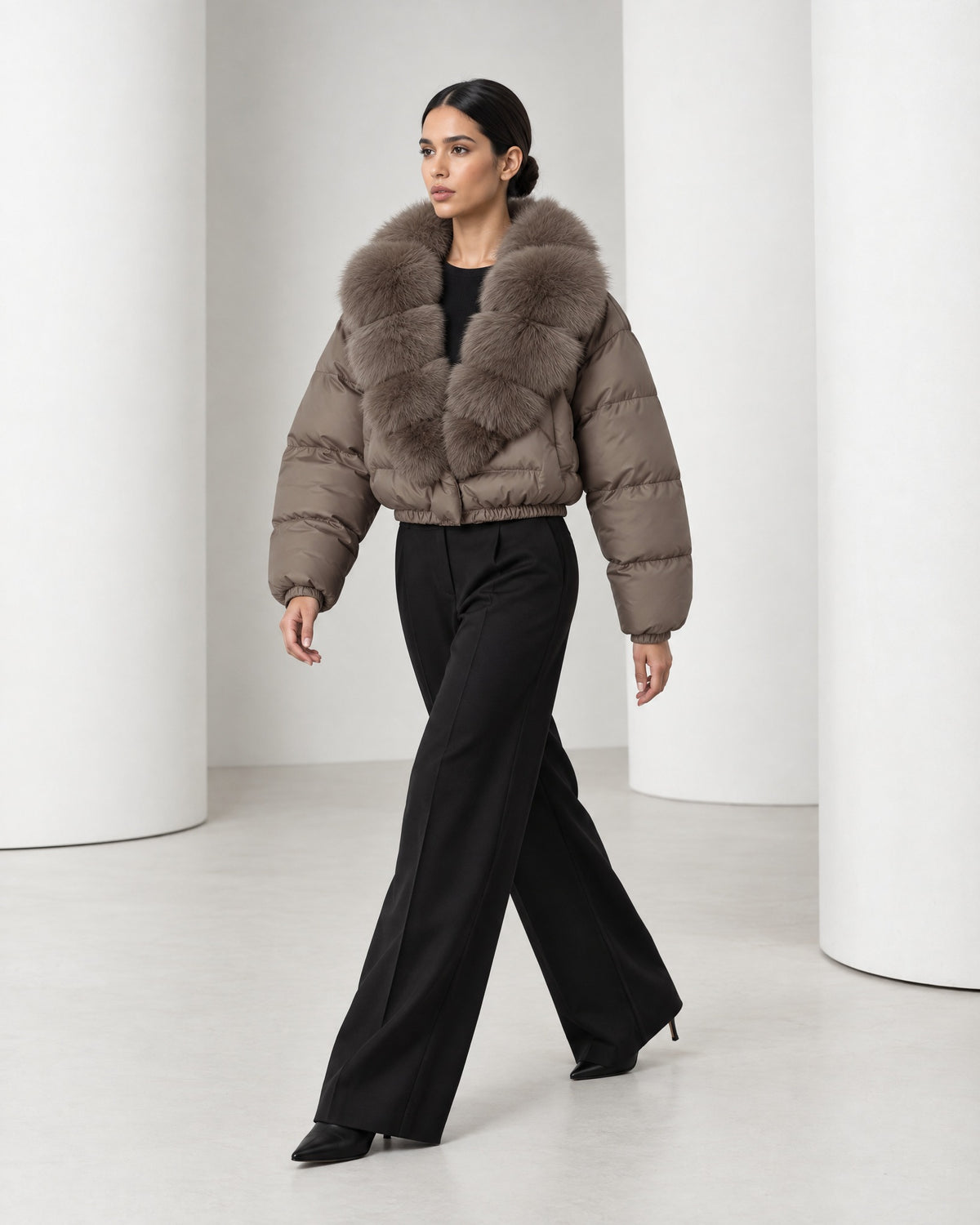 Side view of the Saga taupe puffer mid-stride, showing the waist-length crop and the full rounded sleeves