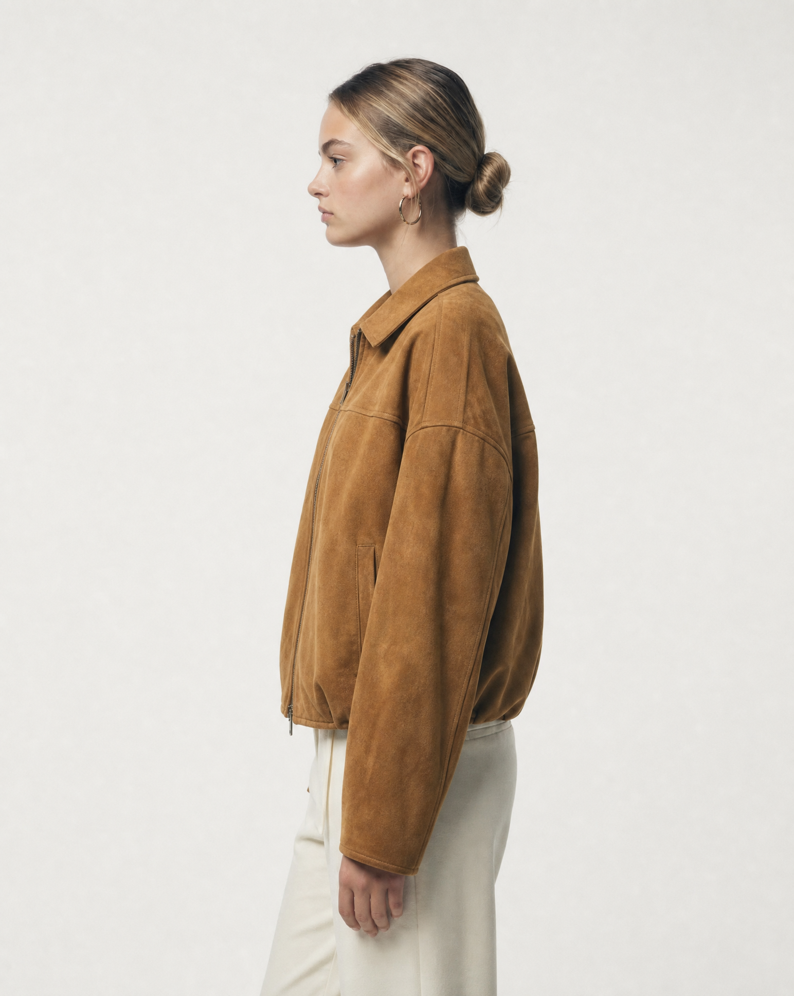 Tan suede Selena Jacket seen from the side, drop shoulder seam and boxy sleeve, cropped at the hip
