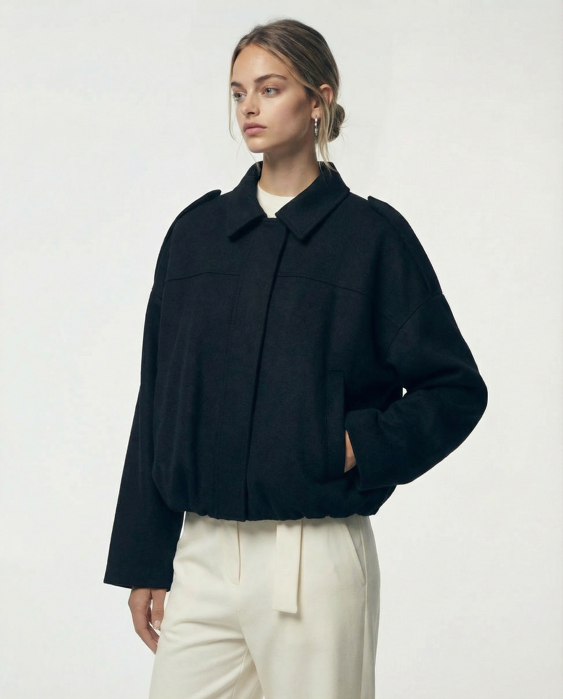 Black Selena Jacket in brushed wool, worn closed at a three-quarter angle with a hand in the pocket