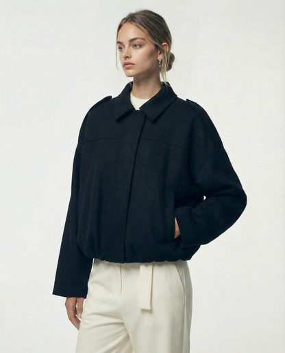 Black Selena Jacket in brushed wool, worn closed at a three-quarter angle with a hand in the pocket