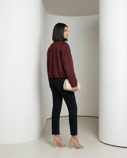 Burgundy suede Selena Jacket from behind at a three-quarter angle, gathered hem, full length