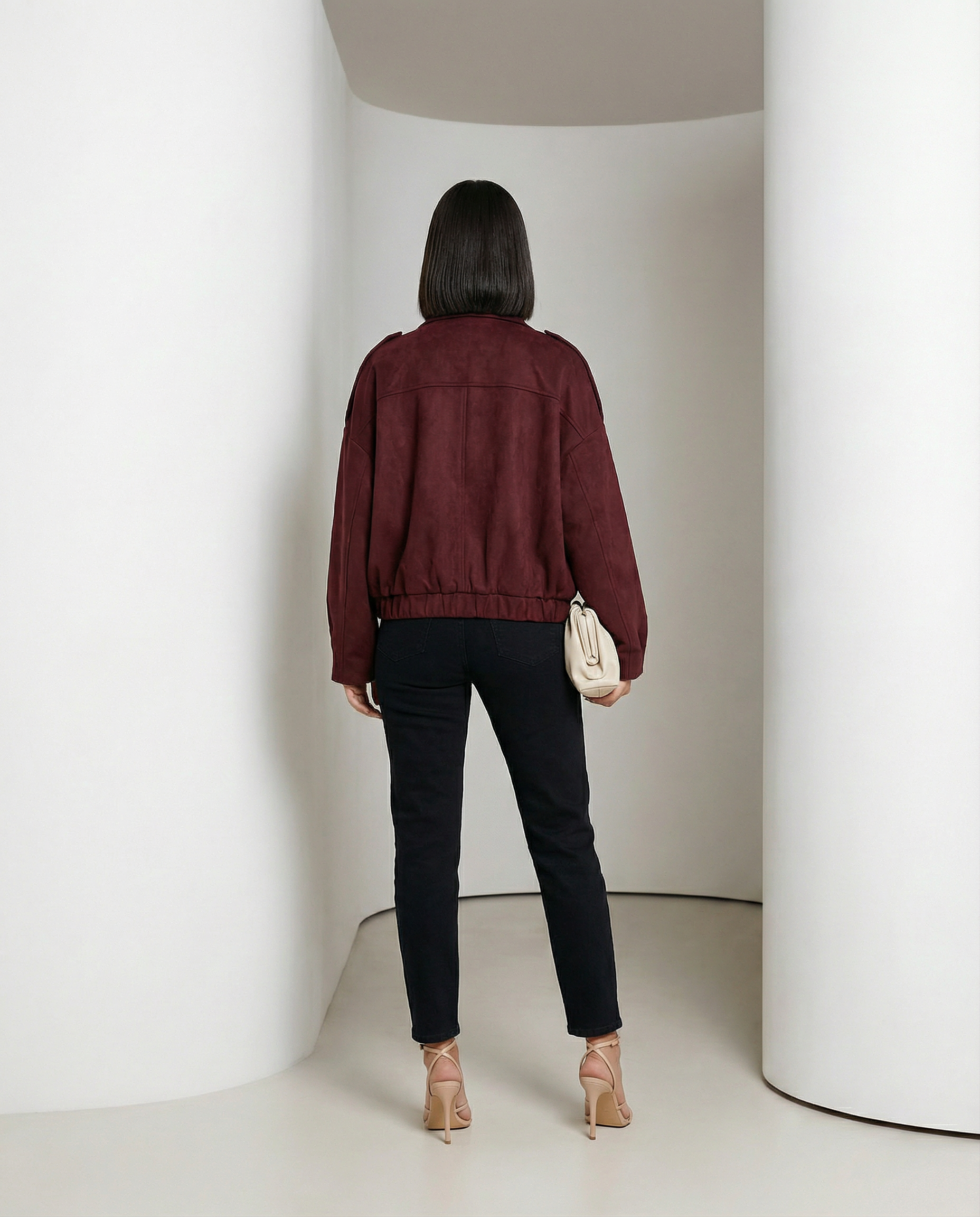 Burgundy suede cropped bomber from behind, elasticated hem gathered at the hip, full length back view