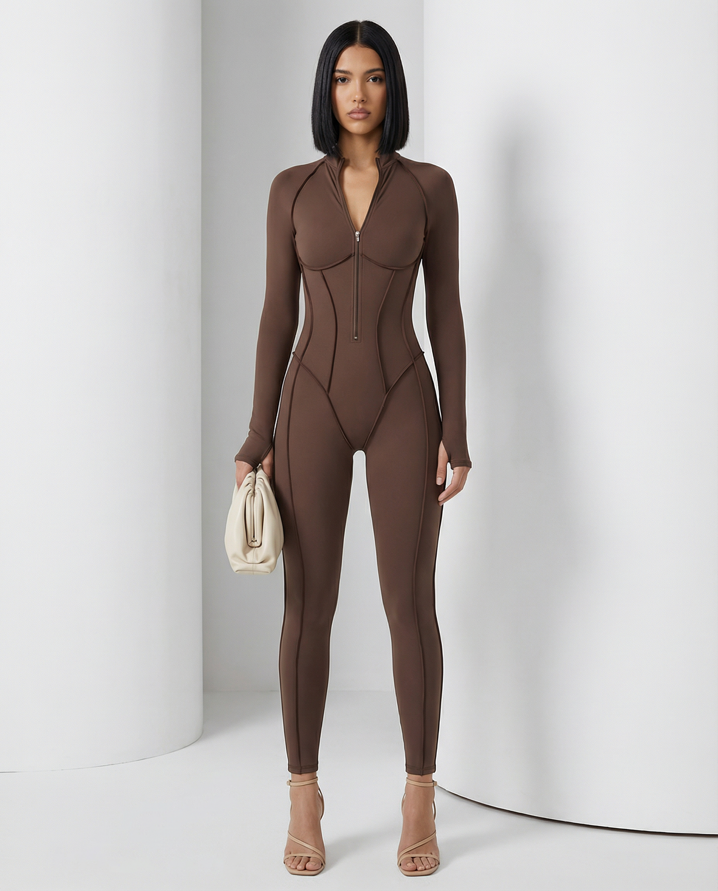 Selene Sculpt Jumpsuit in bitter chocolate with zip front and corset seaming, front view