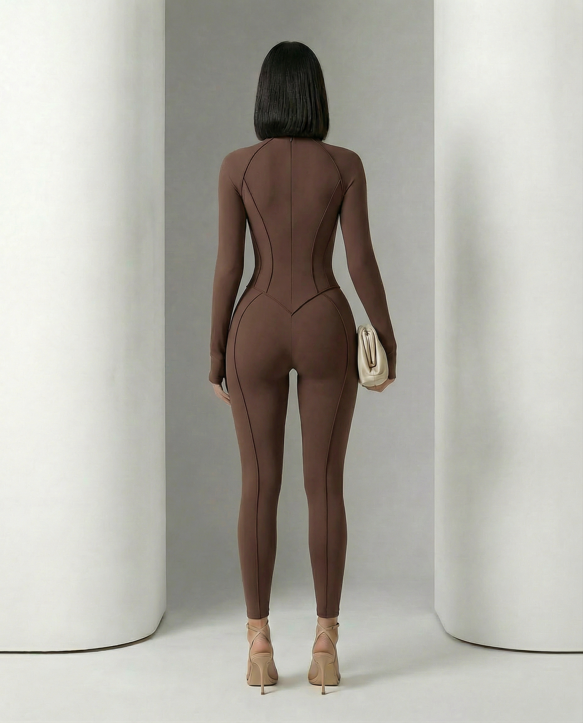 Back view of the bitter chocolate jumpsuit showing shaped seat panels and centre back seam