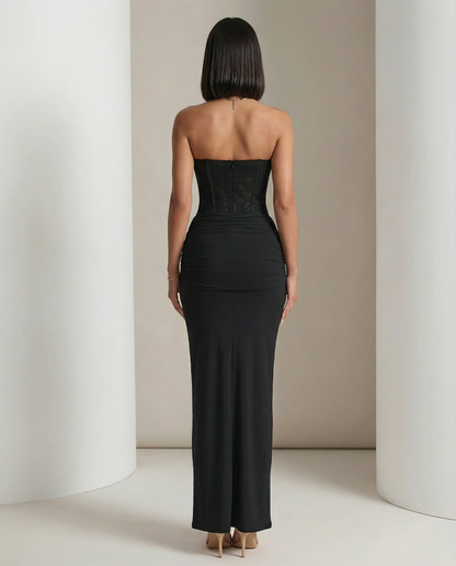 Black corset maxi dress from behind, ruched hip panel and straight back neckline, full length