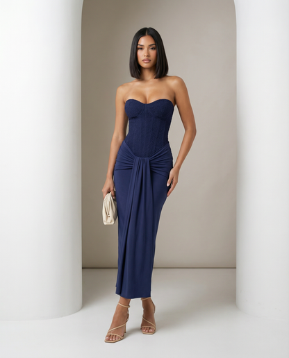Navy blue Siren Dress with a textured strapless corset bodice and knotted drape, full length front