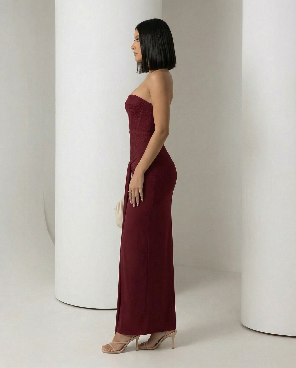 Burgundy Siren Dress seen from the side, boned corset bodice over a floor-sweeping column skirt