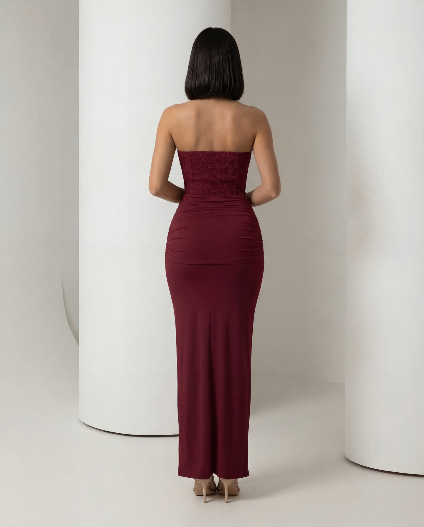 Burgundy corset maxi dress from behind, ruched back skirt and straight neckline, full length back view
