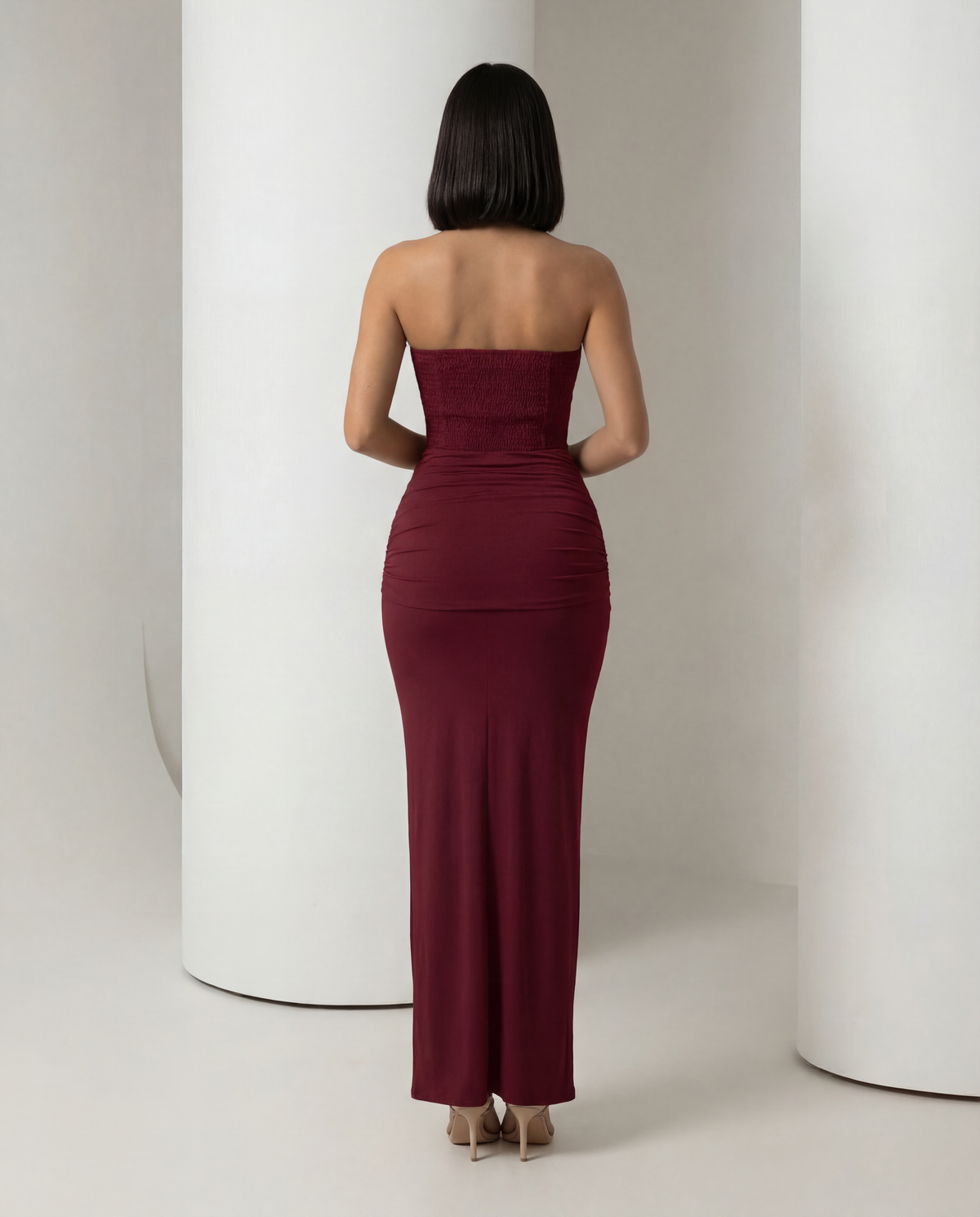 Burgundy corset maxi dress from behind, ruched back skirt and straight neckline, full length back view