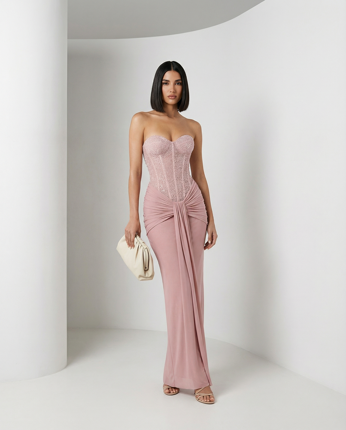 Dusty rose Siren Dress with a beaded strapless corset bodice and draped skirt, full length front