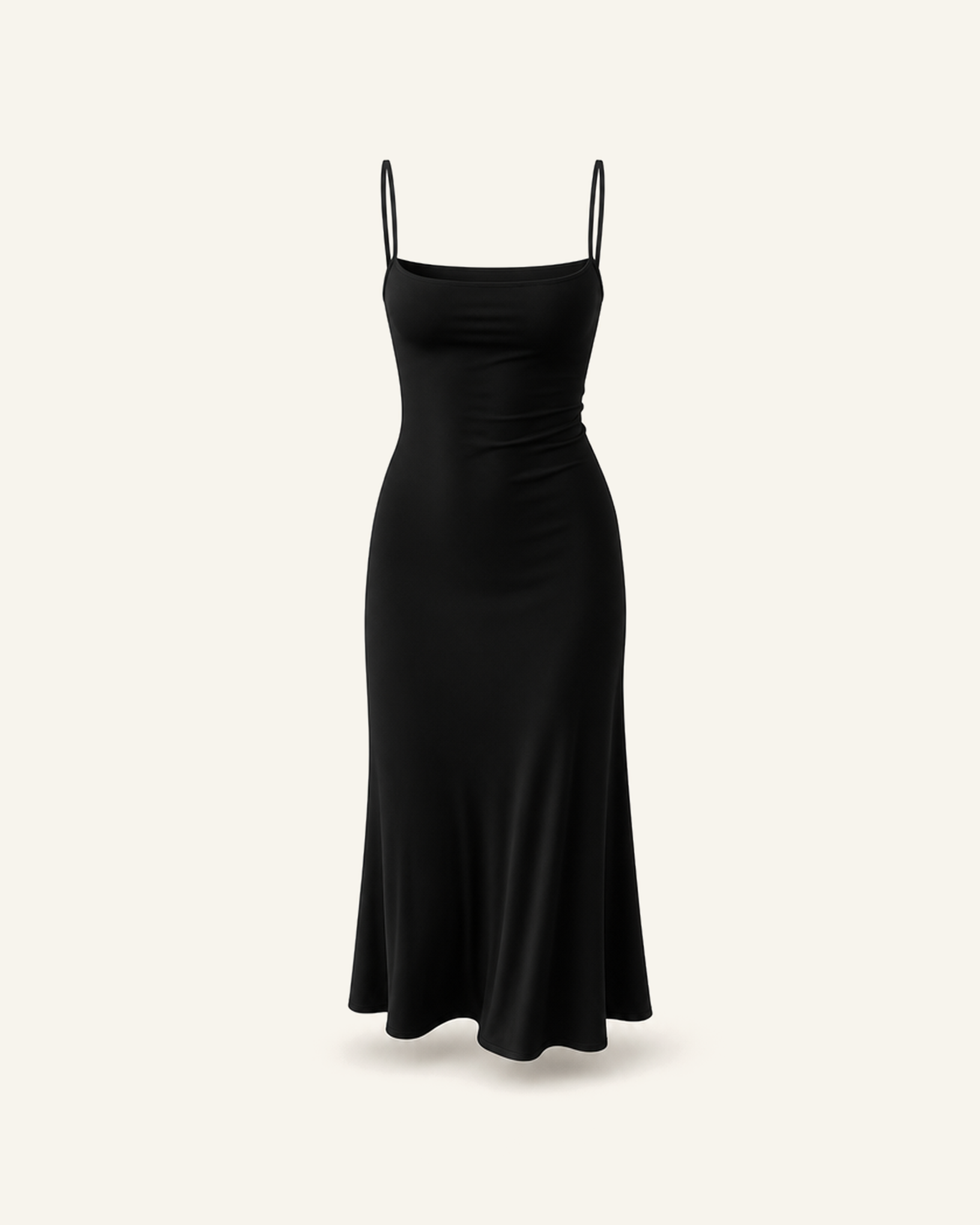 The Siv midi slip dress in black, narrow straps, straight neckline and a fluted hem, alone on a bone background