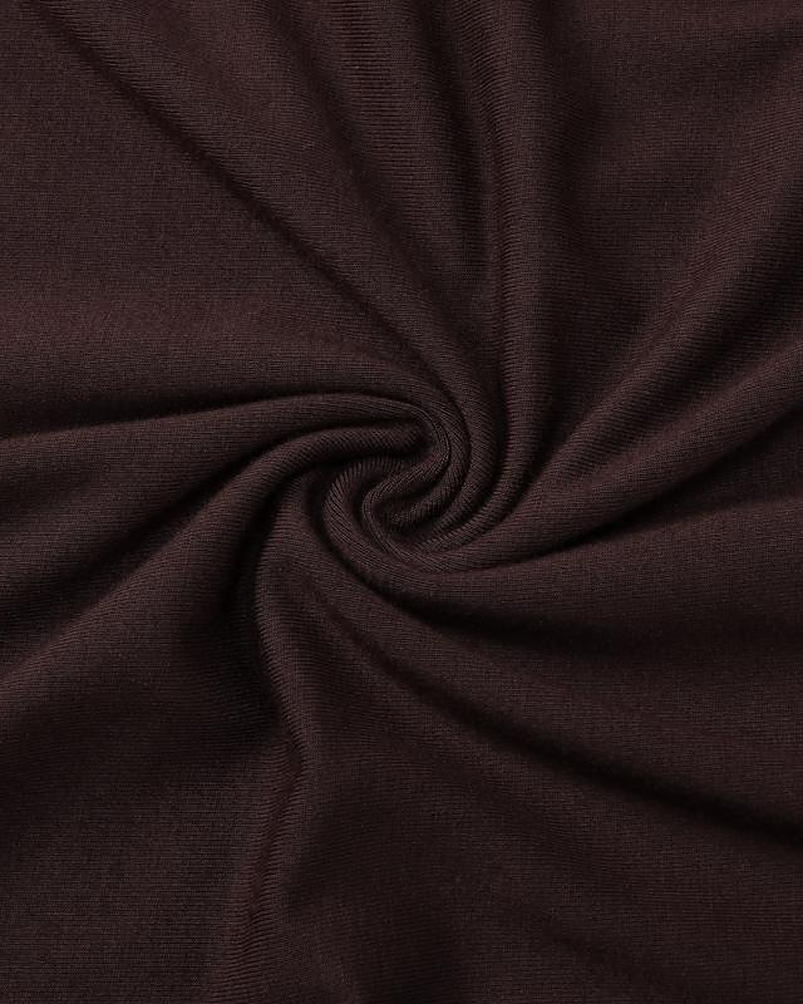 Macro of the Siv espresso jersey, showing the fine knit surface and the way it takes light