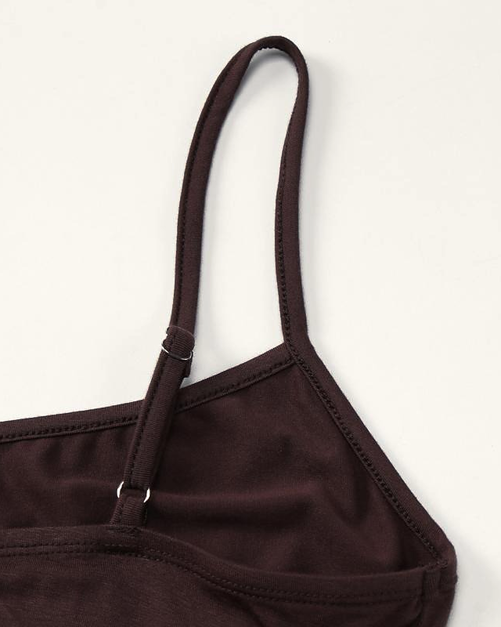 Construction detail of the Siv slip dress, the narrow self-fabric strap and its metal slider