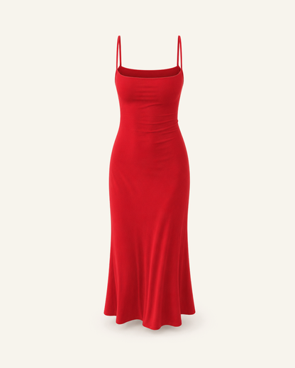 The Siv midi slip dress in red, narrow straps, straight neckline and a fluted hem, alone on a bone background