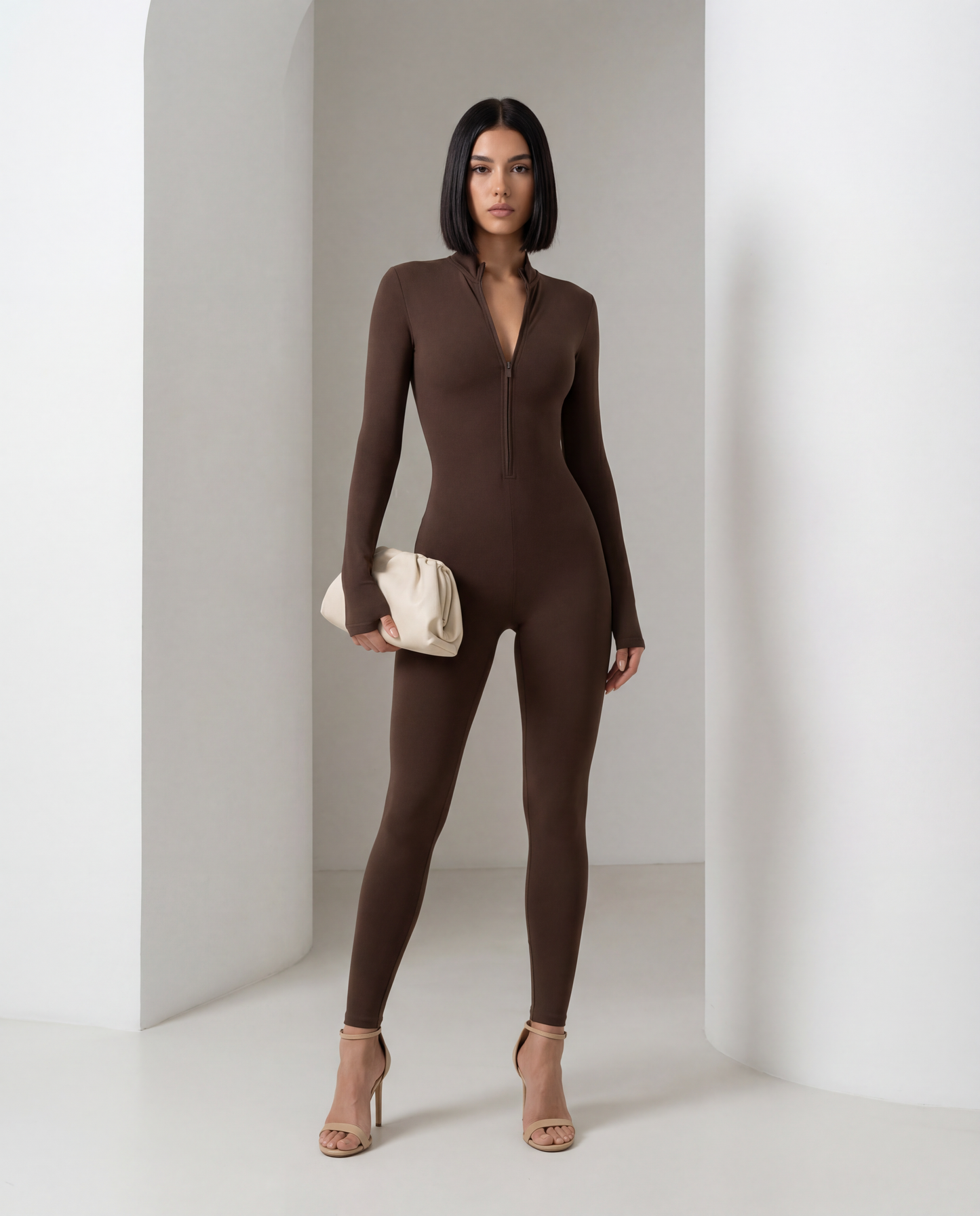 Bitter chocolate long-sleeve jumpsuit, front view showing the seamed bodice and ankle-length legs