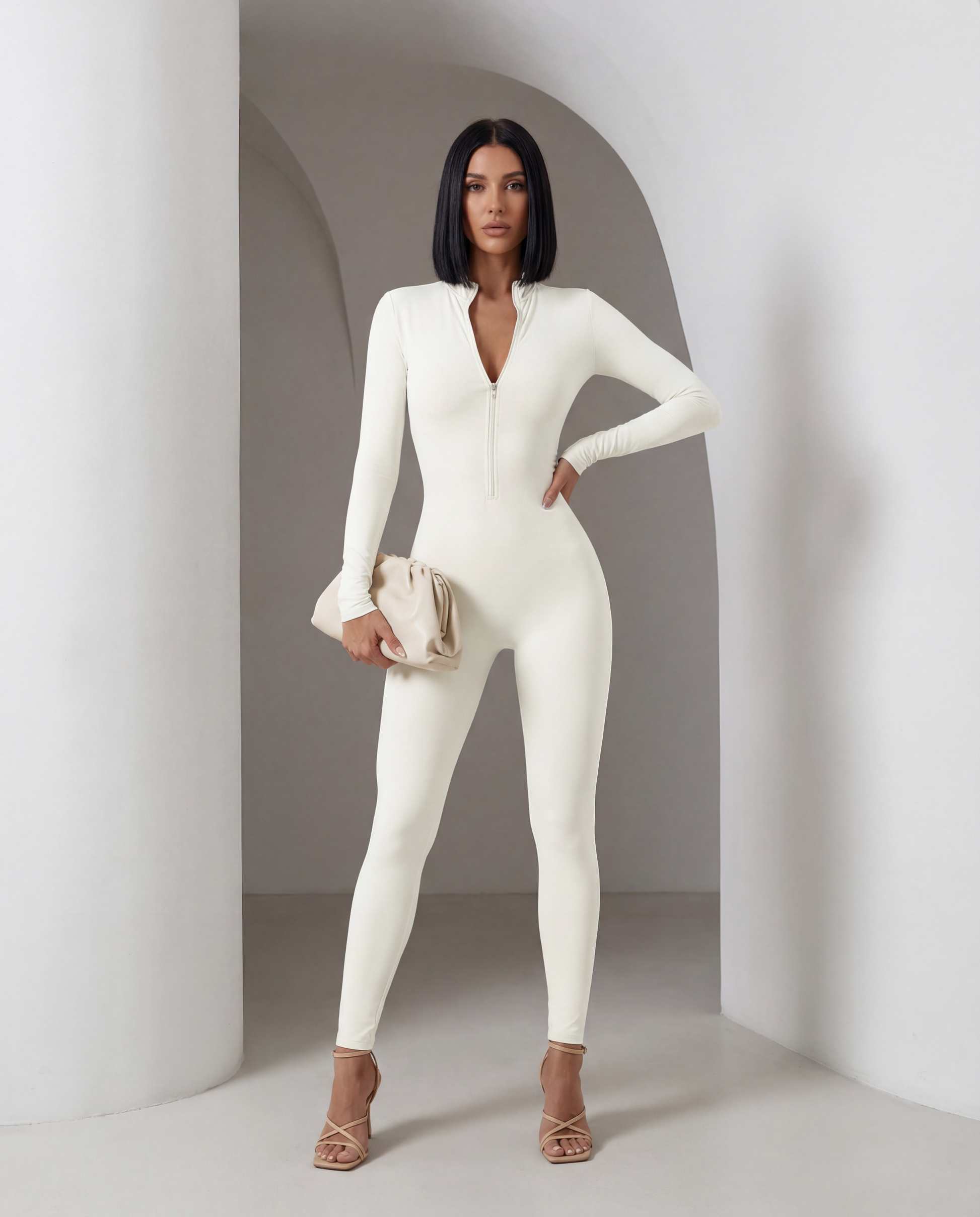 Ivory long-sleeve jumpsuit with the front zip open at the chest, full length front view