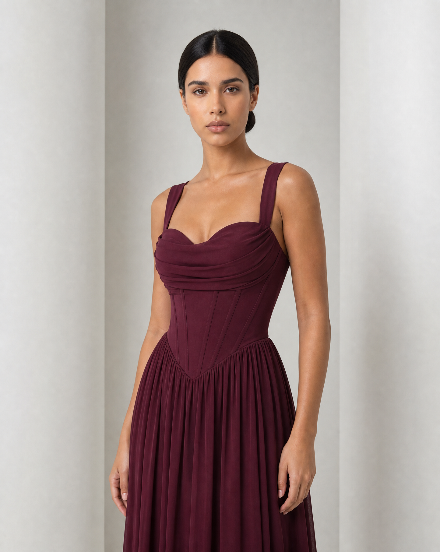 Draped cowl neckline and panelled corset bodice of the Solveig gown in burgundy